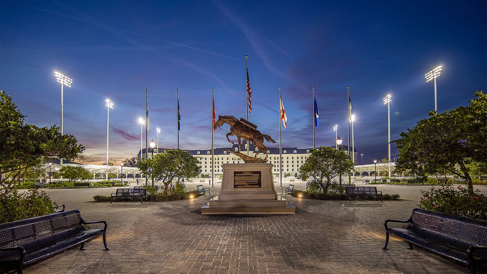 Horse statue in front of the Equestrian Hotel entrance at dusk.